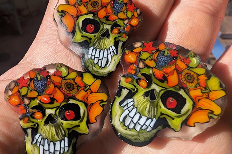 Glass murrine created by Stephen Boehme of skulls with vegetables and flowers