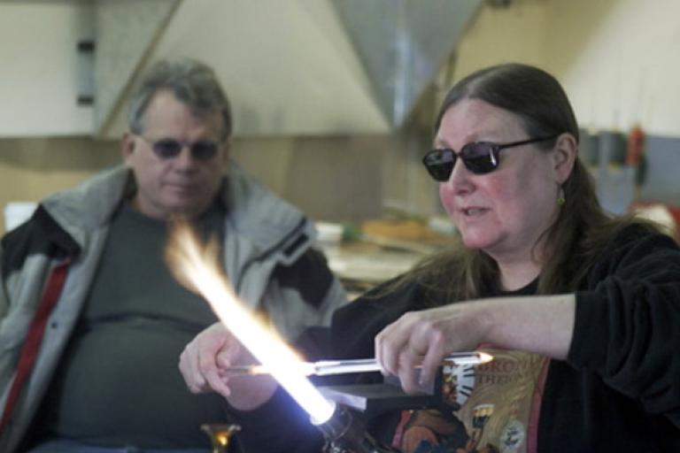 Artist Suellen Fowler demonstrating the flameworking process