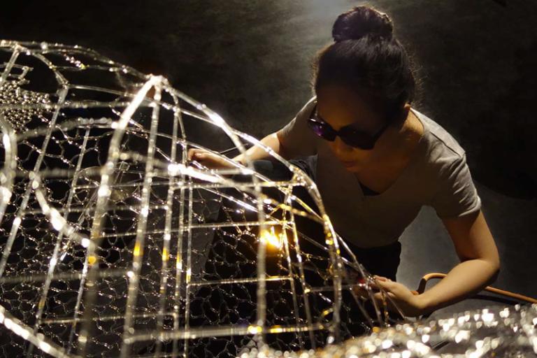 Artist Kim KototamaLune creating glass sculpture with hand held torch
