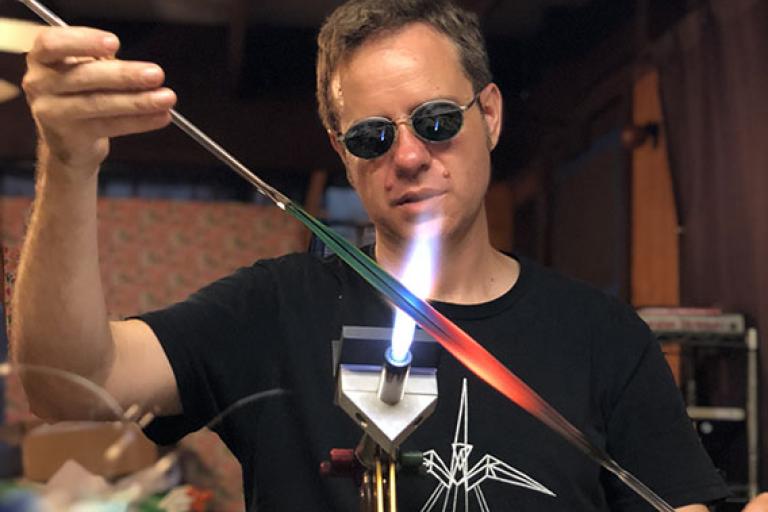 Artist Jupiter Nielsen working glass at the torch