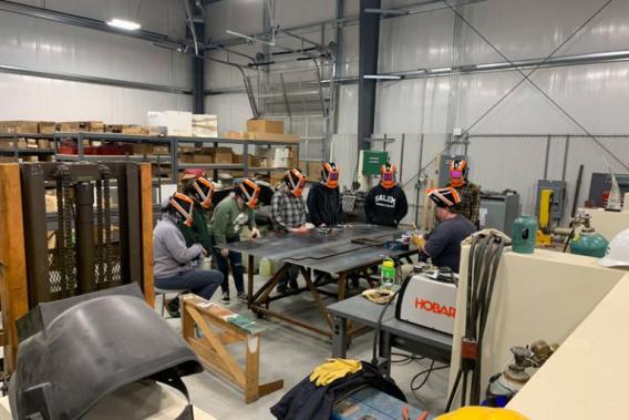 Students and instructor welding 