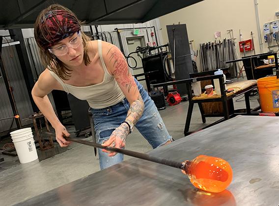 Woman working in the glassblowing studio