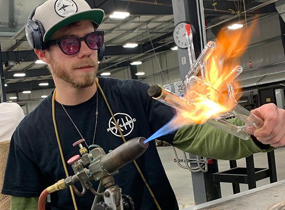 Student making scientific glass at the torch
