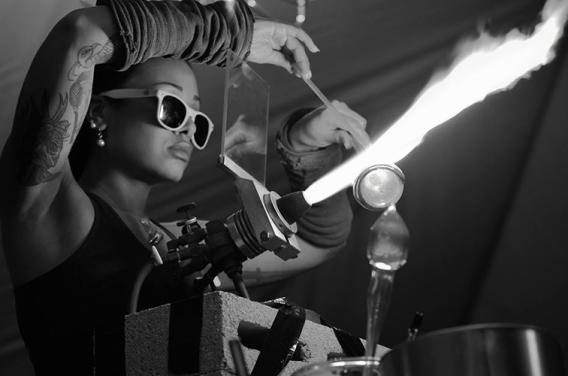 Image of artist Kimberly Thompson working on glass with a torch